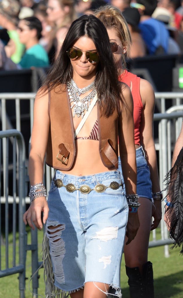 Kendall played up her look with key accessories, including chunky silver necklaces and bracelets, a concho belt, a neutral fringed crossbody bag, and rimless aviator sunglasses.