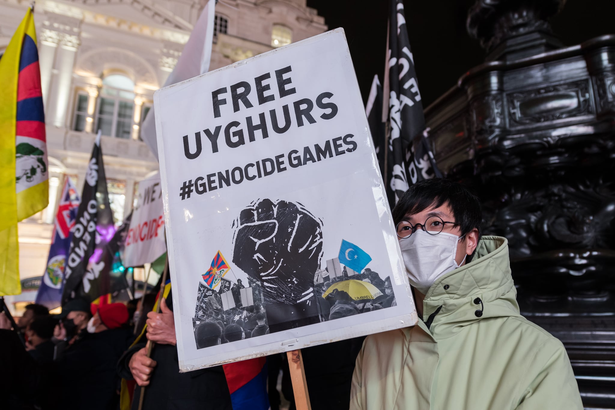 LONDON, UNITED KINGDOM - FEBRUARY 03, 2022: A demonstrator holds a placard as Hongkongers, Tibetans, Uyghur Muslims, their Tigrayan allies and supporters protest in Piccadilly Circus on the eve of Beijing 2022 Winter Olympic Games on February 03, 2022 in London, England. The demonstrators protest against the International Olympics Committee's (IOC) decision to award this year's Winter Olympics to China amid the country's record of human rights violations in Hongkong and Tibet as well as crimes against humanity against Uyghurs and other Turkic Muslims in the northwestern region of Xinjiang. (Photo credit should read Wiktor Szymanowicz/Future Publishing via Getty Images)