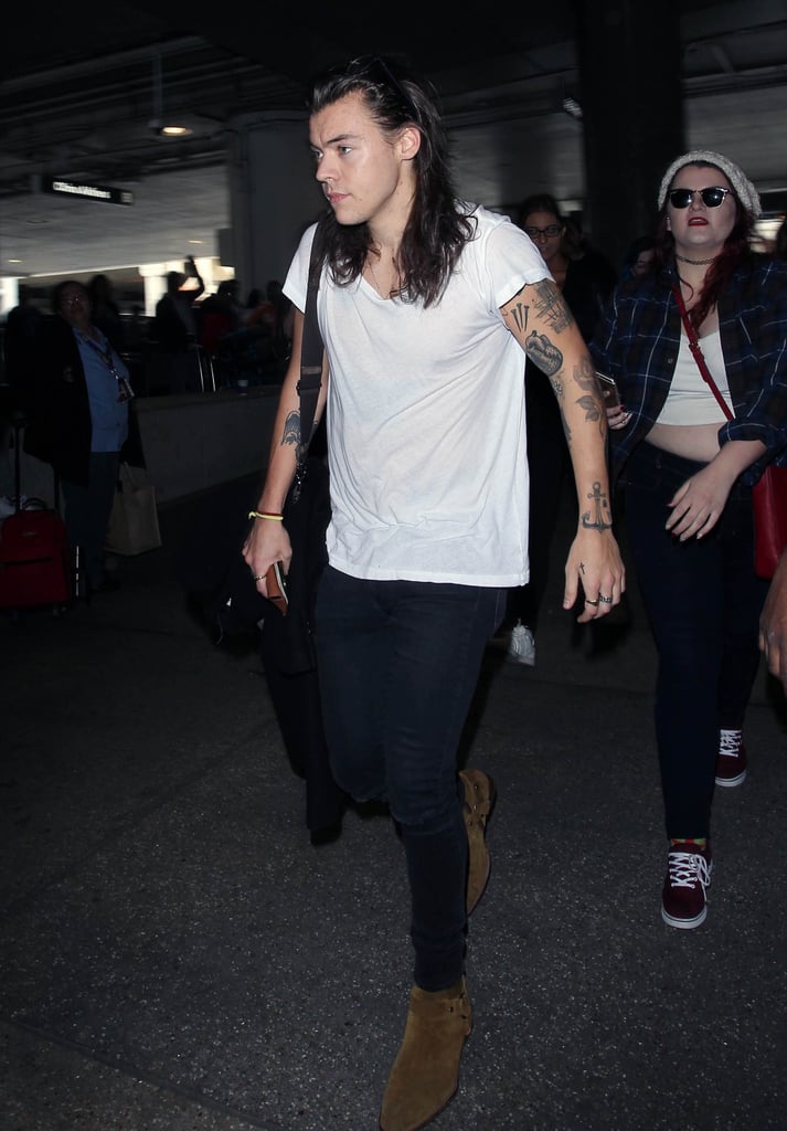 At the airport in 2016 wearing tan Saint Laurent boots.