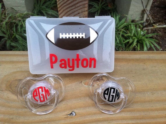 monogrammed pacifiers and a case