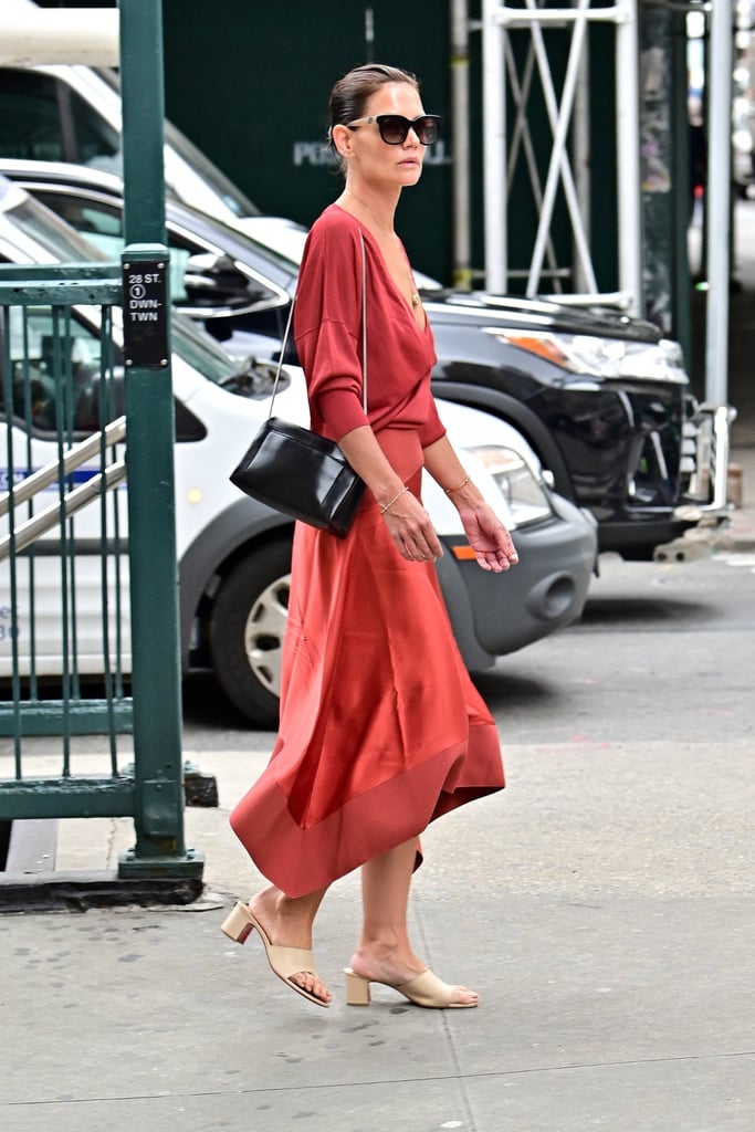 Katie counters the ultrachic vibe of a slip skirt and sweater with slightly undone hair and neutral, easy slides. It's perfect because it just doesn't try too hard.