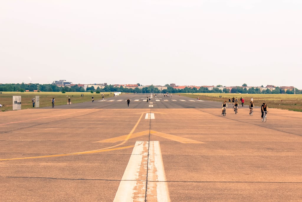 Speaking of running wild and free, if you're seeking an extra-unique outdoor experience, head over to Tempelhof Airport Park. What once served as the largest and grandest airport in all of Germany is now Berlin's largest park! 
Here, you'll find people partaking in all sorts of activities — roller-blading, biking, running across the old runaways, you name it. With 909 acres, this abandoned-airport-turned-park is even larger than New York's Central Park.