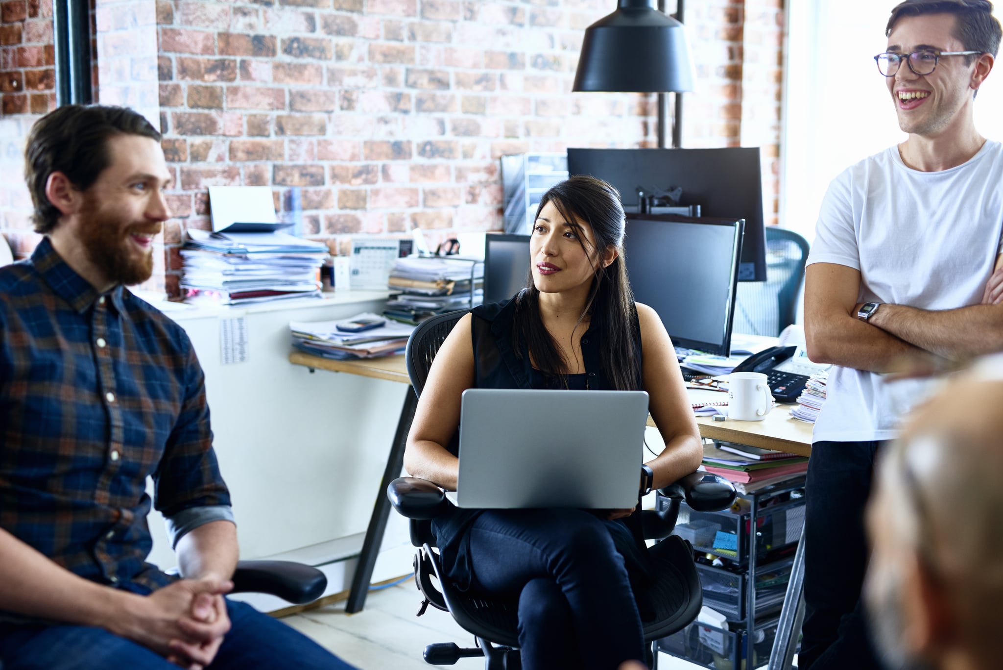 Team of creative people talking and smiling in modern office