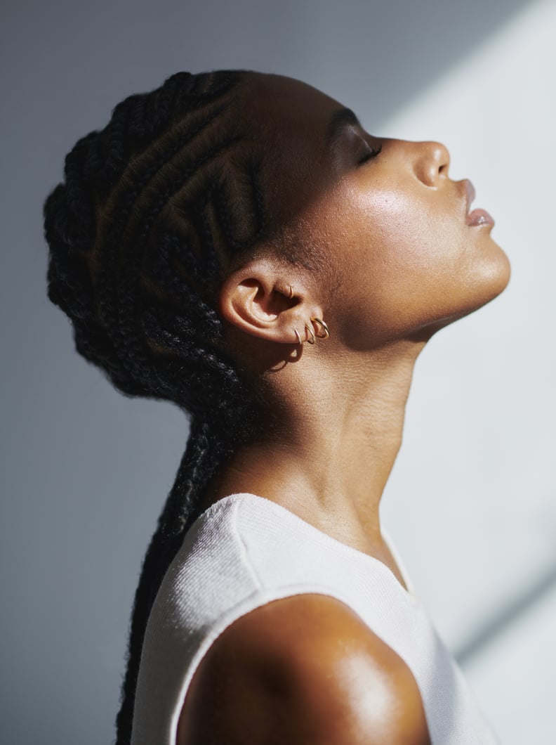 Woman Standing With Her Eyes Closed Enjoying the Sun on Her Face