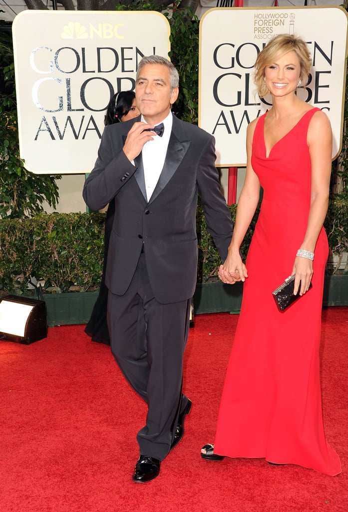 George Clooney fixed his bow tie while escorting Stacy Keibler in 2012.
George Clooney fixed his bow tie while escorting Stacy Keibler in 2012.