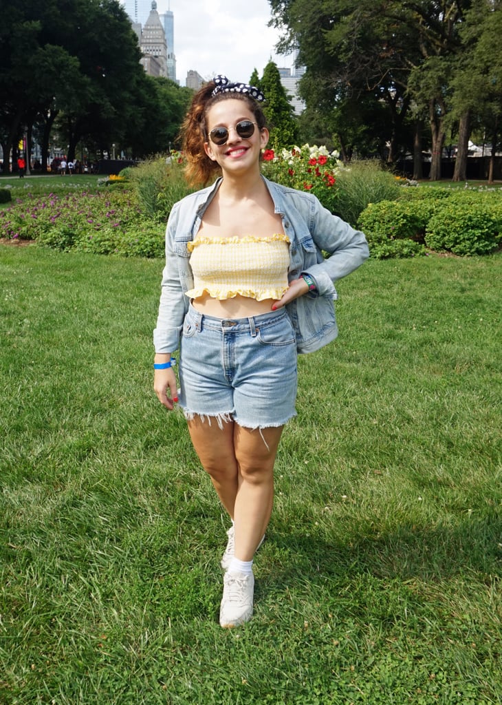 The masculinity of a denim-on-denim outfit is balanced perfectly by a bright, ruffly crop top and graphic hair accessory.