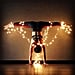 Women Doing Yoga Wrapped in Christmas Lights
