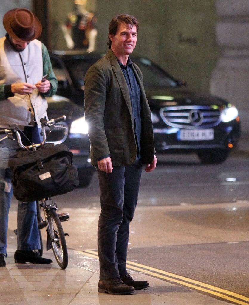 Tom Cruise brought his cheerful disposition to the set of Mission: Impossible 5 in London on Monday.