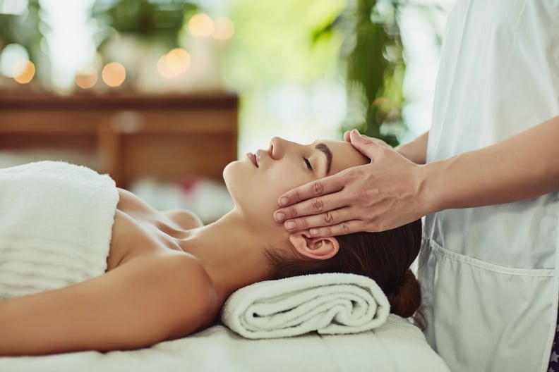 Shot of an attractive young woman getting massaged at a beauty spa