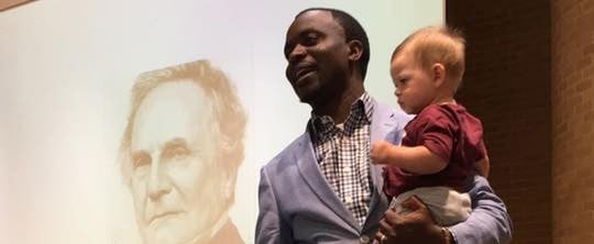 The Sweet Story Behind This Photo of a Professor Carrying a Toddler