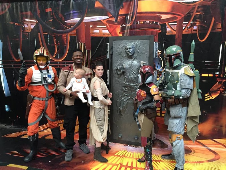 The couple stands with a variety of Star Wars characters, including Han Solo.