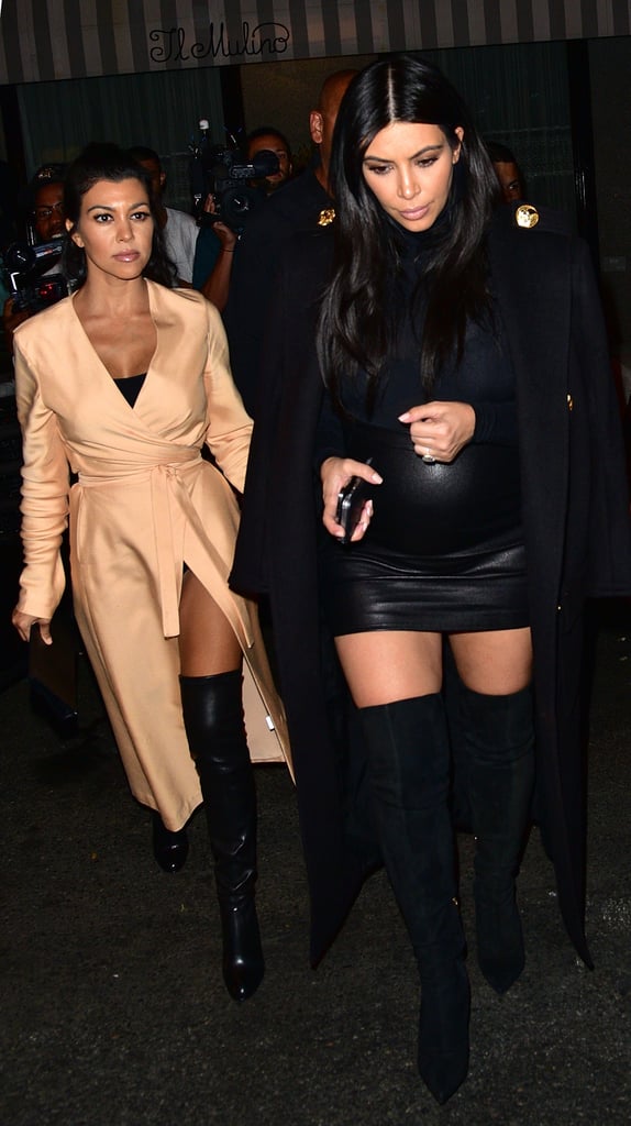 Kim and Kourtney stepped out for a night on the town, both ladies wearing their black over-the-knee boots. While Kourtney threw on a neutral silk robe, Kim was fierce in an extremely tight leather miniskirt, turtleneck, and structured coat.