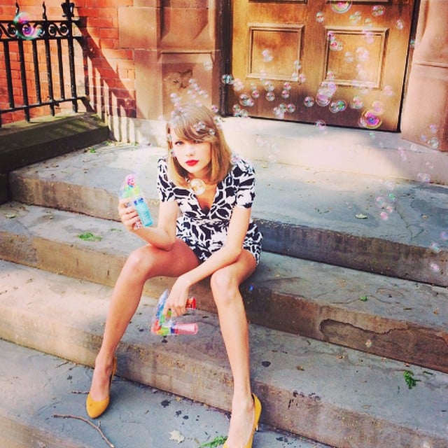 Taylor Swift relaxed with bubbles outside a front stoop in New York City.
Source: Instagram user taylorswift