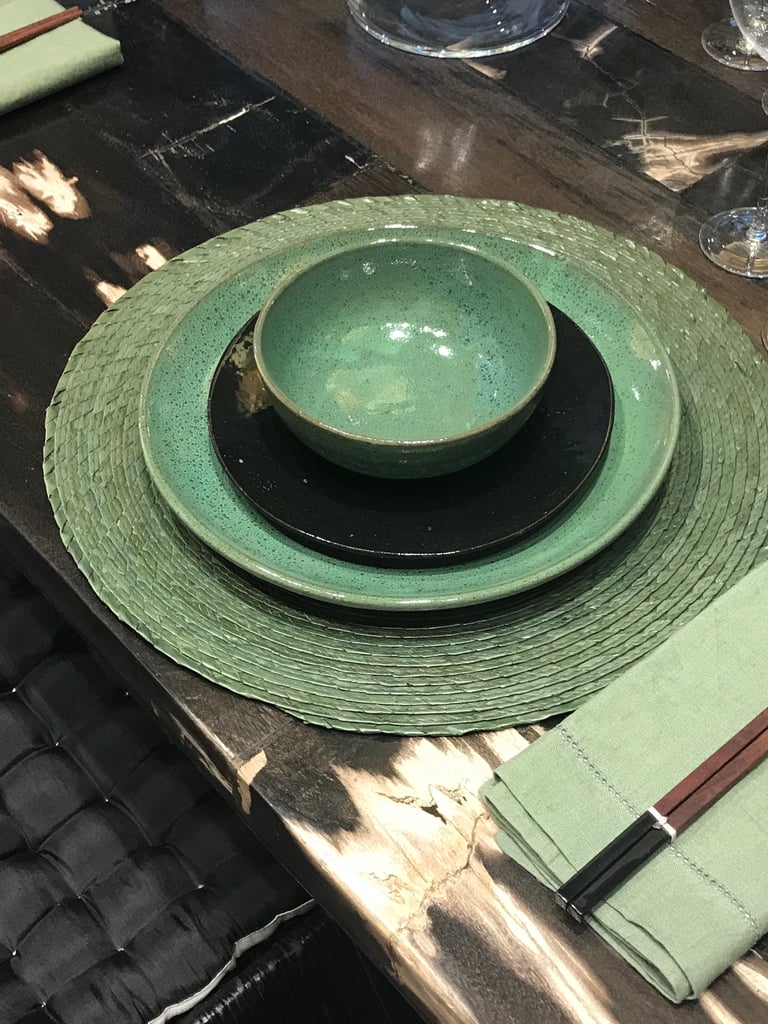 On the tabletop, various shades and textures of teal look elegant and are the perfect backdrop for a bolder print. Nancy explained, "When using bold prints in your home, it's best to have a balance of tonal solids so your prints can stand out."