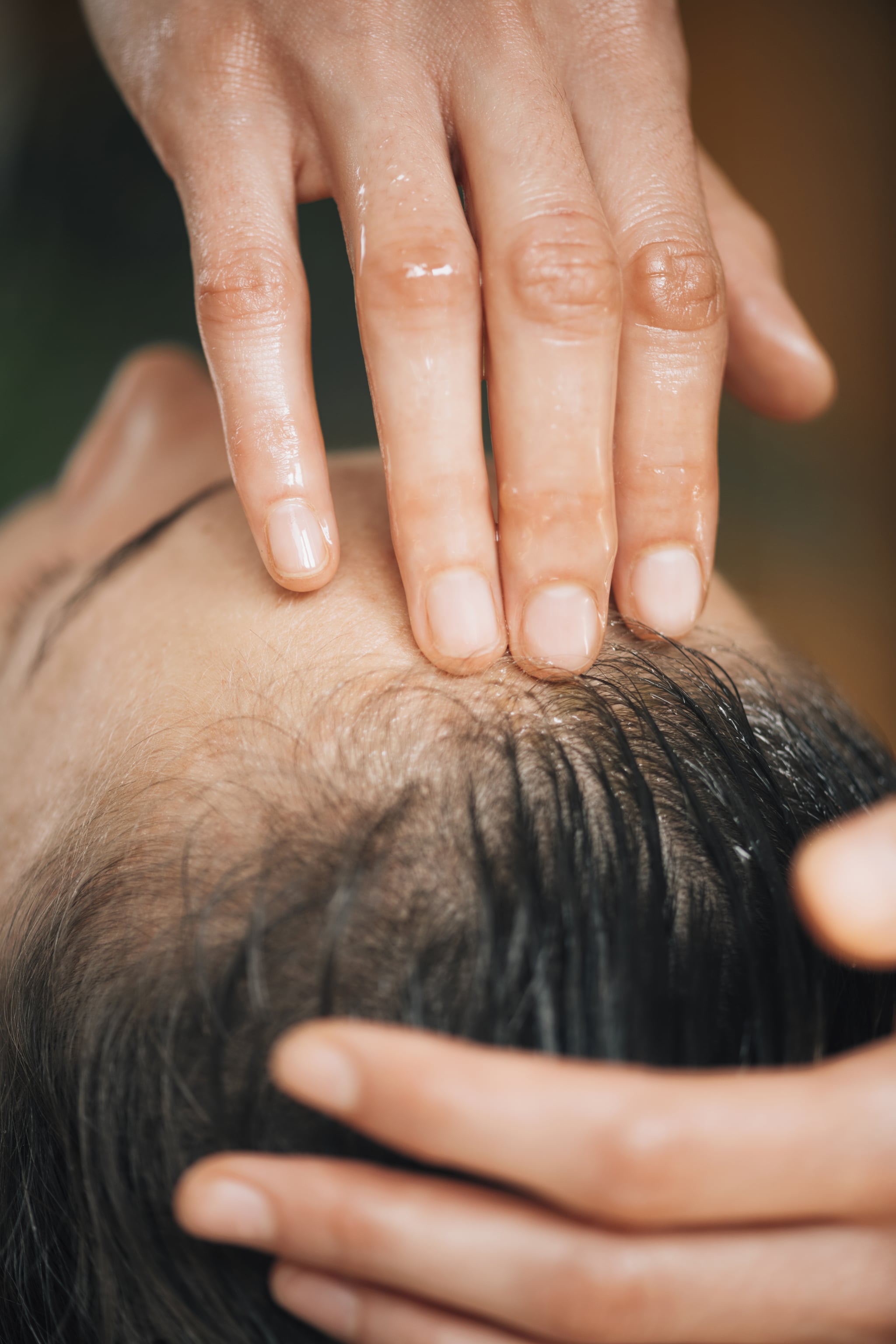 Woman enjoying Ayurvedic oil treatment for healthy hair.