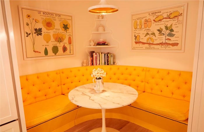 A cheery kitchen nook is Instagram-ready from the wall art to the marble tulip table.