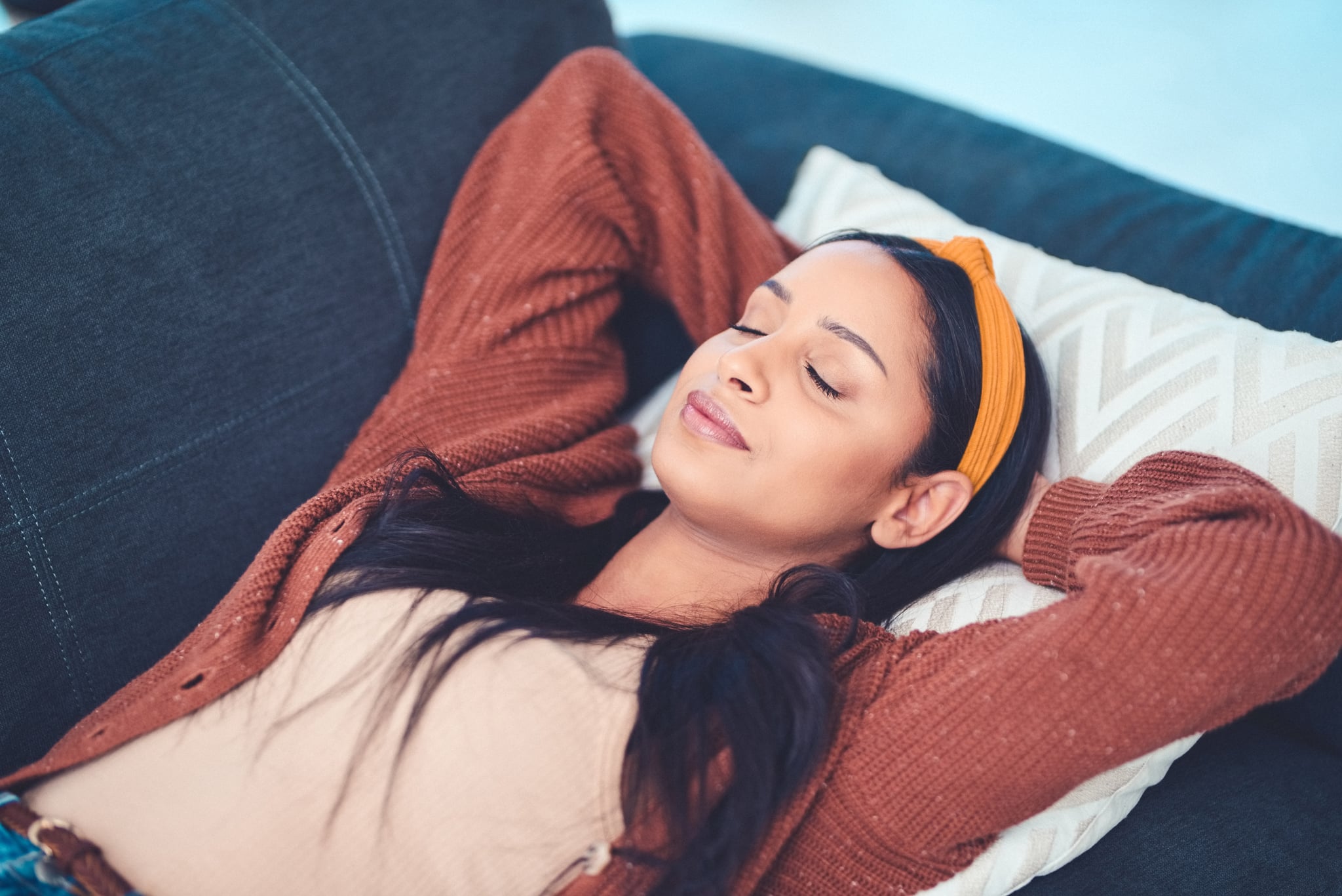 Shot of a young woman relaxing on the sofa at home