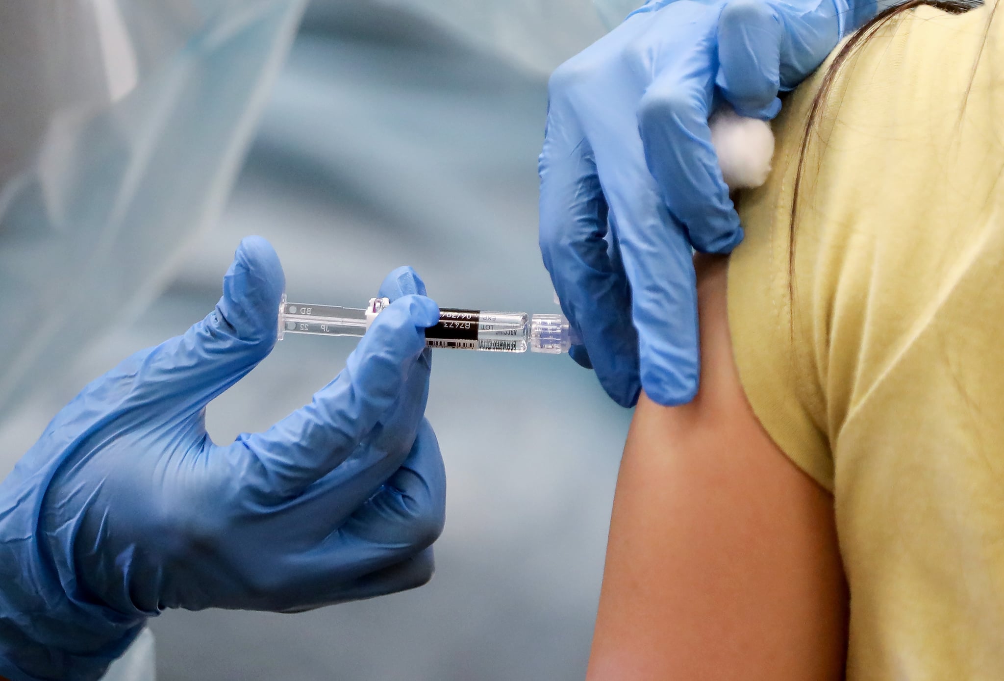 LAKEWOOD, CALIFORNIA - OCTOBER 14: A nurse administers a flu vaccination shot to a woman at a free clinic held at a local library on October 14, 2020 in Lakewood, California. Medical experts are hoping the flu shot this year will help prevent a 'twindemic'- an epidemic of influenza paired with a second wave of COVID-19 which could lead to overwhelmed hospitals amid the coronavirus pandemic. (Photo by Mario Tama/Getty Images)