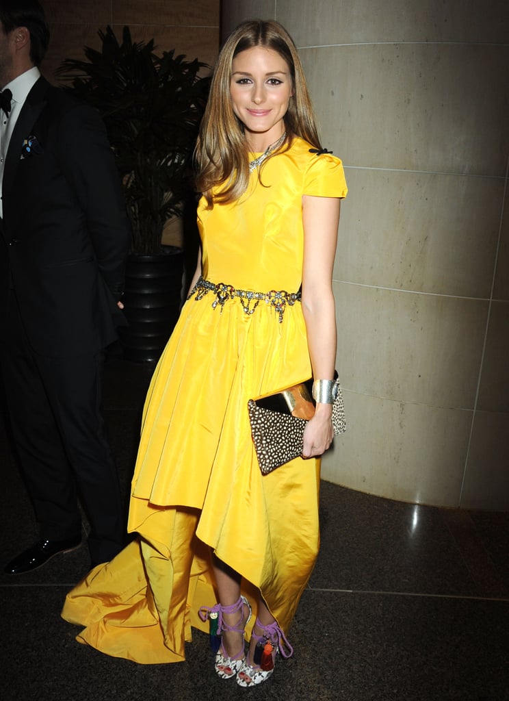 Though we're nearly certain we won't see Olivia in any color outside of the ivory family, there are potential clues in the shape of the daffodil-yellow Katie Ermilio gown she picked for a New York City event.
