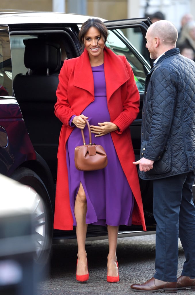 Meghan didn't shy away from colour whatsoever when she styled this Babaton purple midi with a cherry Sentaler coat and covetable Gabriela Hearst handbag for a visit of Birkenhead at Hamilton Square in January 2019.