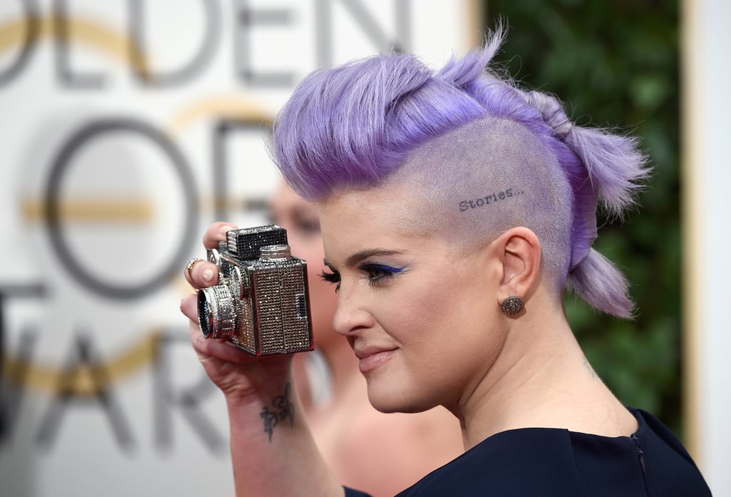 Kelly Osbourne played paparazzi with her clever camera clutch.