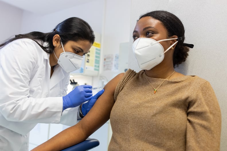 Young woman receiving a vaccine shot against a virus