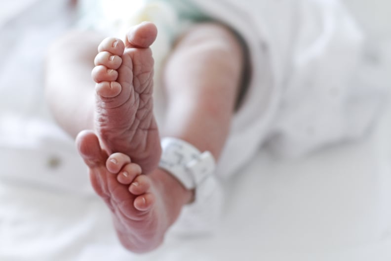 Newborn baby boy at hospital with identity tag on feet, close up