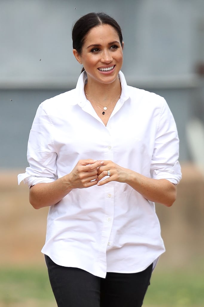 When she took off her blazer, Meghan wore her sleeves in her signature rolled-up style.