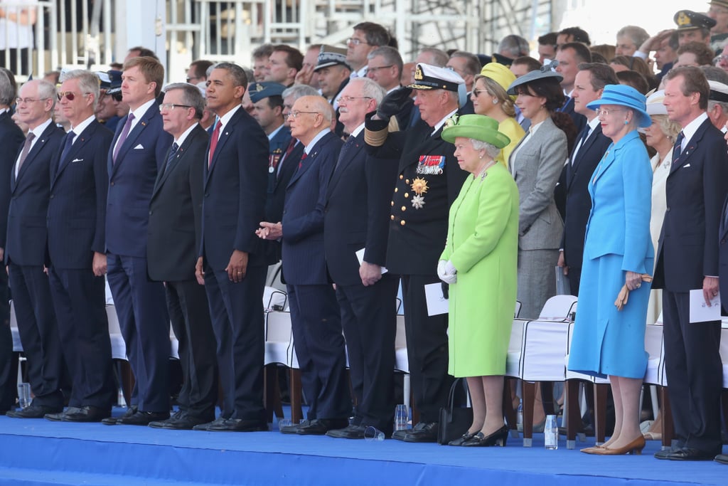 The queen stands out as much shorter than other notable figures like Former President Barack Obama.