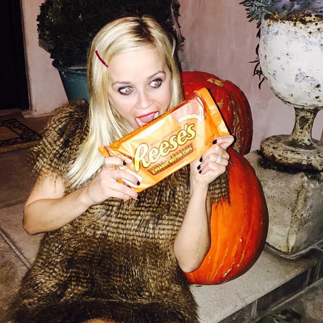 Reese pretended to munch on a Reese's Peanut Butter Cup.