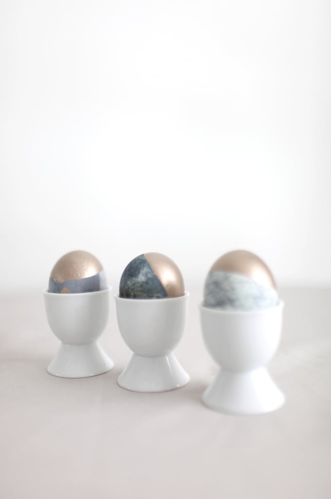 Step 4:
Dip egg partially into a cup of gold paint. Place upside down in an egg carton to dry.