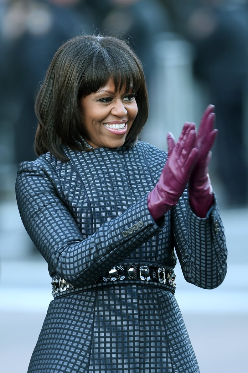 WASHINGTON, DC - JANUARY 21:  First lady Michelle Obama walks the route as the presidential inaugural parade winds through the nation's capital January 21, 2013 in Washington, DC. Barack Obama was re-elected for a second term as President of the United St