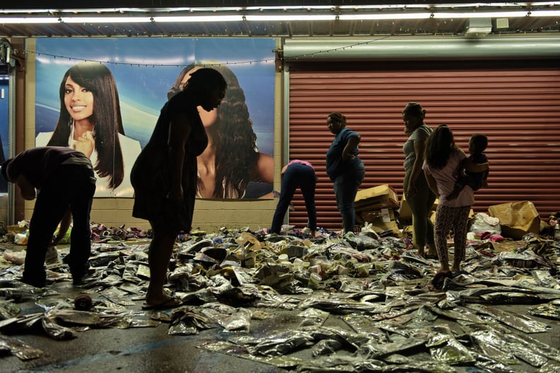 People sort through the damage outside of stores in Baton Rouge, LA.