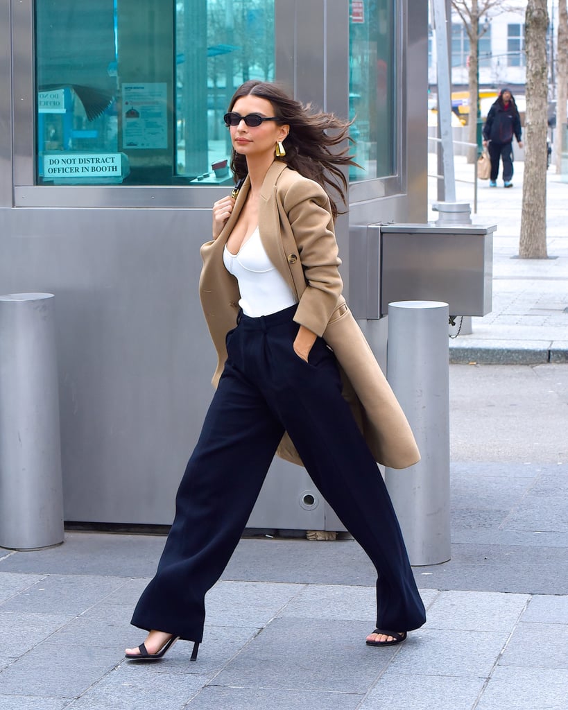 Work one under a neutral trench and trousers with heels in the Fall to achieve a boss lady outfit with sex appeal. Emily Ratajkowski's got a handle on it, see?