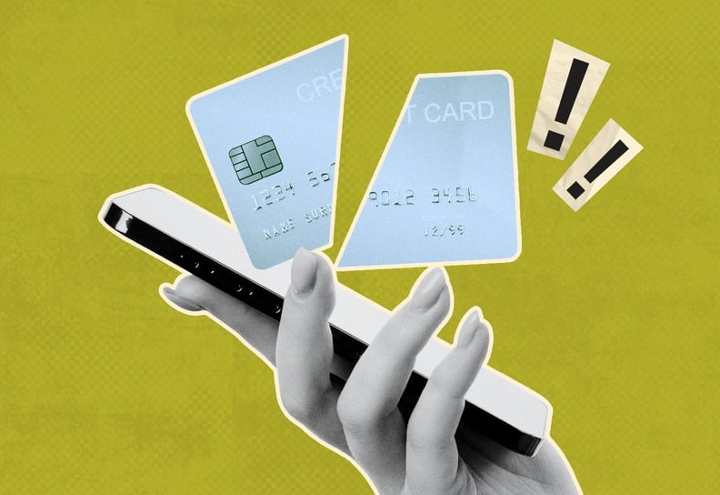 a person holding a smartphone and a cut credit card