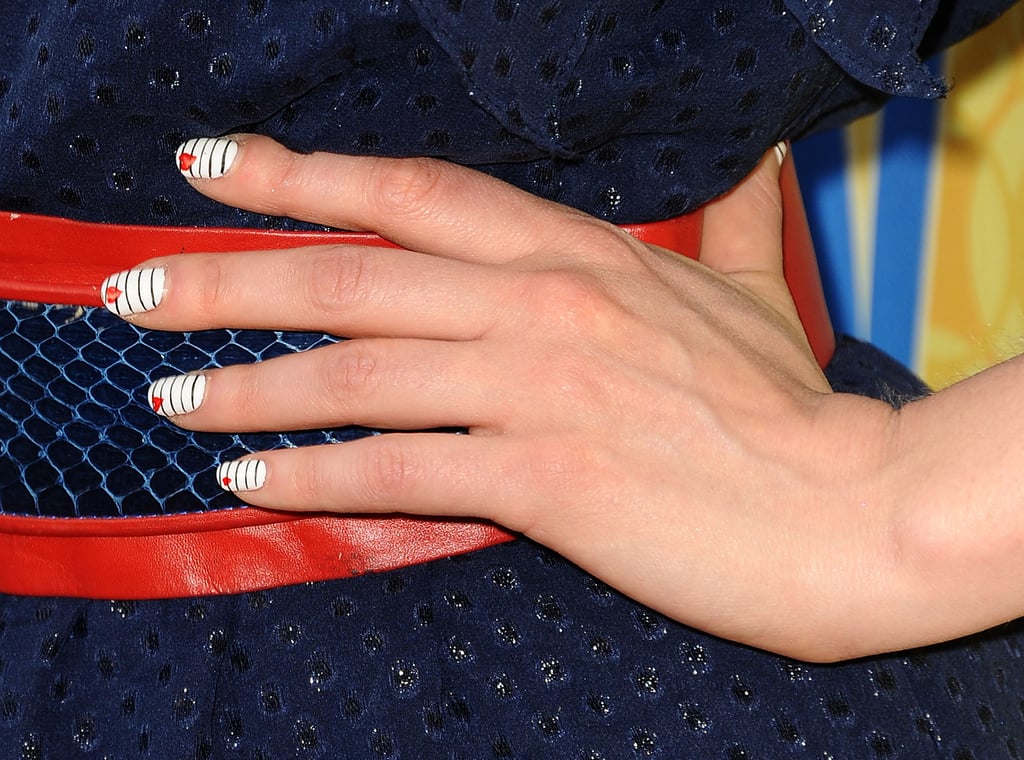 At a special screening of New Girl, Zooey rocked a striped manicure with a small heart accent on each nail.