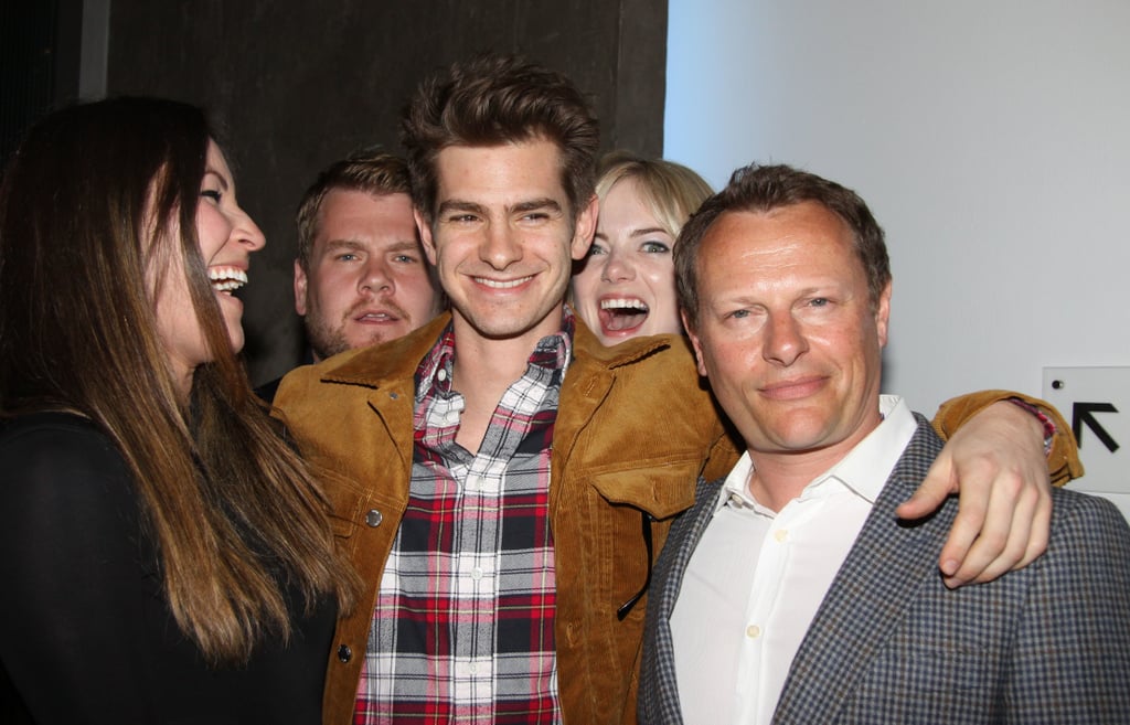 Emma hilariously photobombed Andrew at the afterparty for the play Bull's opening night in May 2013.
