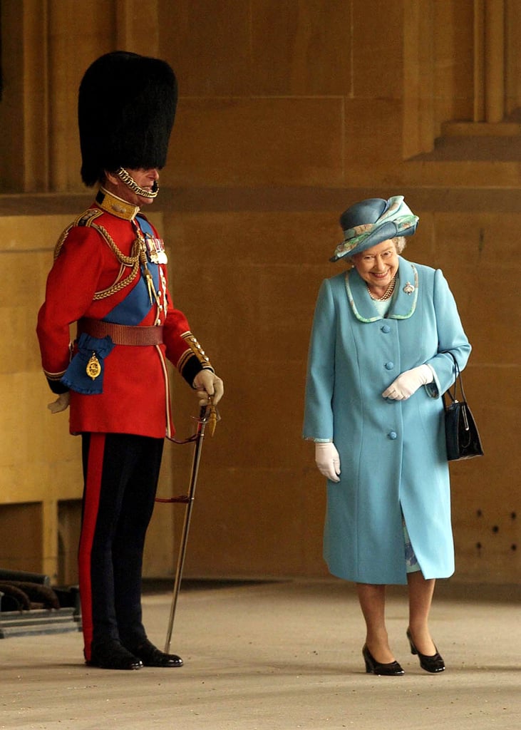 Queen Elizabeth II couldn't help but laugh as she passed her husband at Buckingham Palace in 2005.