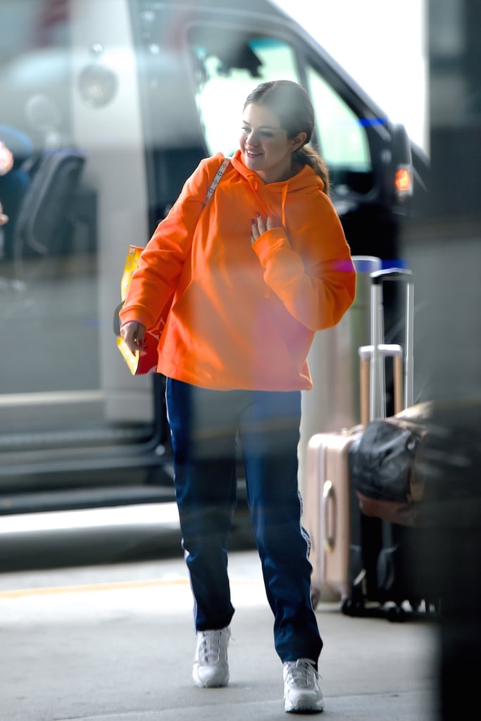 Selena Gomez's Louis Vuitton Bag and Sneakers at the Airport
