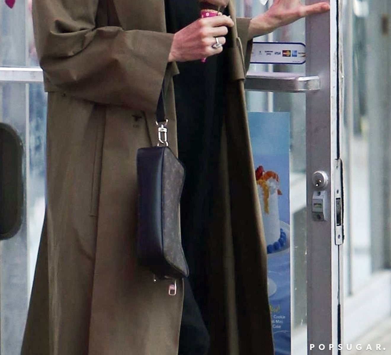 Angelina Jolie Wears Louis Vuitton Gold Clutch Cuffed To Her Wrist