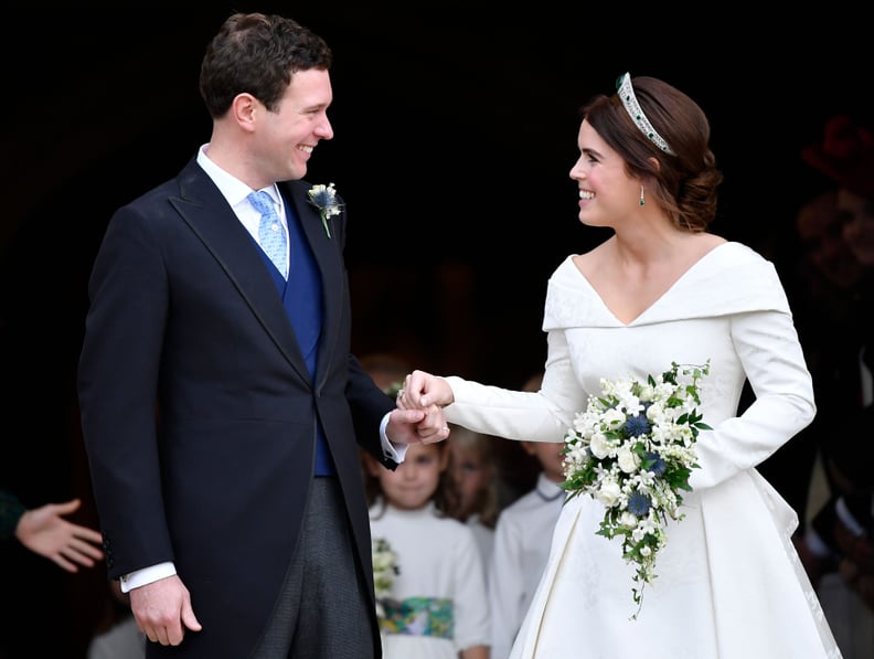Britain's Princess Eugenie of York (R) and her husband Jack Brooksbank emerge from the West Door of St George's Chapel, Windsor Castle, in Windsor, on October 12, 2018 after their wedding ceremony. (Photo by TOBY MELVILLE / POOL / AFP)        (Photo credi