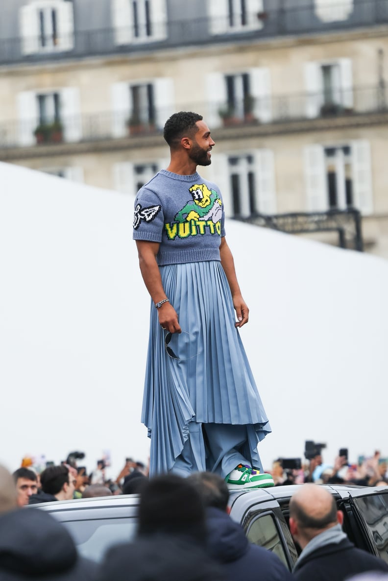 Lucien Laviscount makes quite the entrance in a blue pleated skirt during  Paris Fashion Week