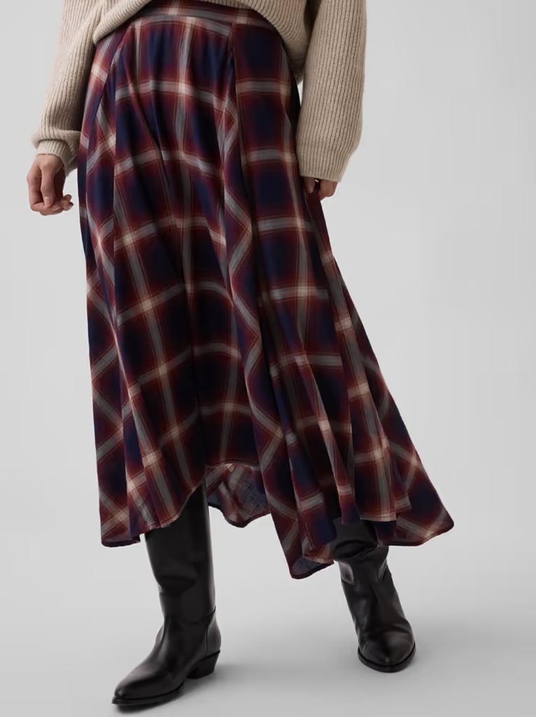 Gap Plaid Maxi Handkerchief Skirt ($100)
Asymmetrical skirts were everywhere this summer and widely loved for their flowy finish. This skirt lets you transform the trend for fall with two different plaid print offerings. Team it with your favorite pair of leather boots for seamless styling.