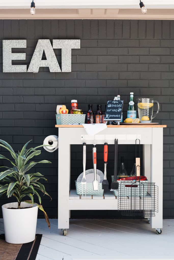 No outdoor kitchen would be complete without some countertop and storage space. Enter: a DIY island cart loaded with everything needed for grilling. Overhead, Monica hung some adorable cafe lights ($55) to create ambiance.