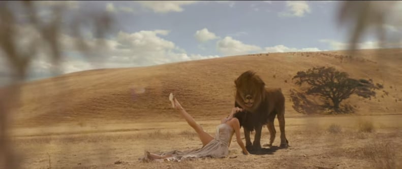 Kicking Back in a Revealing Dress — Next to a Lion