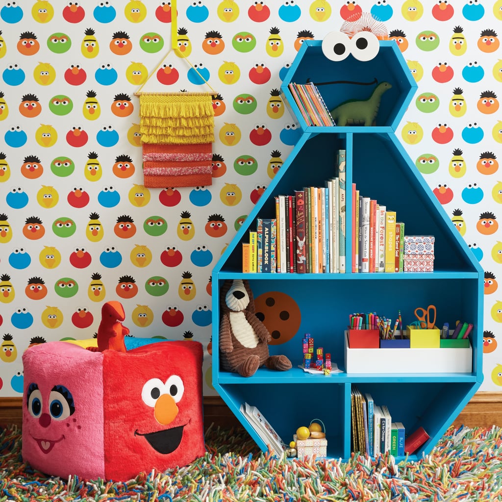 Cookie Monster Bookcase ($424, originally $499), Sesame Street Friends Fur Pouf ($129), Wall Decal ($49), and Big Bird Woven Wall Hanging ($20)
