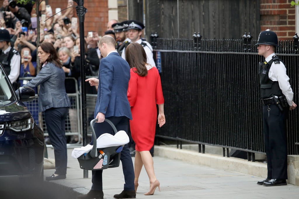 As they had following the birth of George and Charlotte, Kate and William held hands while walking to their car with newborn Louis. They had the confidence of seasoned pros as William held the car seat casually by his side and Kate walked comfortably in heels. 
While the pair didn't give an interview outside of St. Mary's, William did comment to waiting reporters that they were "very happy" and "very delighted" joking that they "didn't keep [the press] waiting too long this time." The parents were clearly conscious of how speedy the whole process had been, but unapologetic.