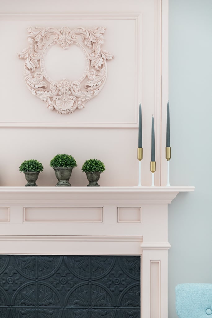 Monica attached molding to the edges of the mantel, and above it she installed an antique-style applique ($69). The overall effect is one of a much more expensive fireplace.