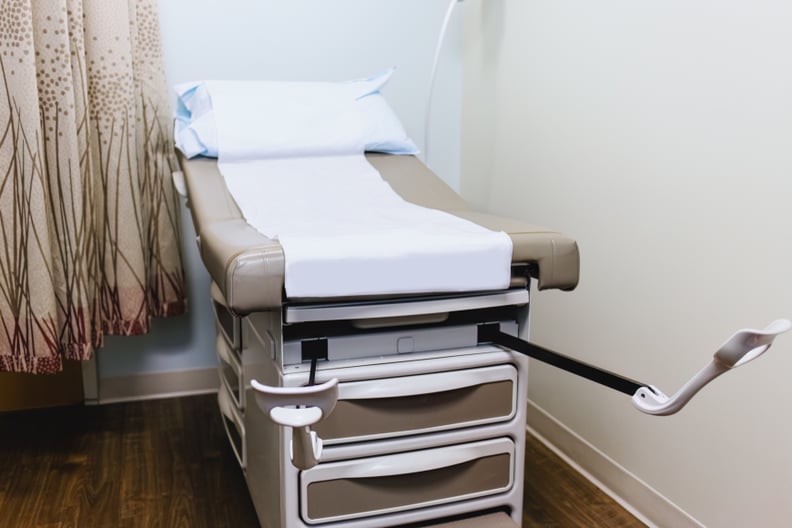 Close-up of examination table with stirrups in gynecologist's office