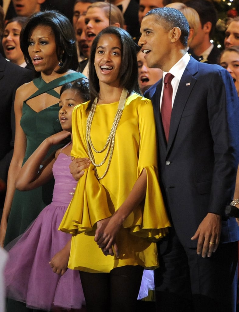 Wearing an Elizabeth and James yellow bell-sleeved dress.